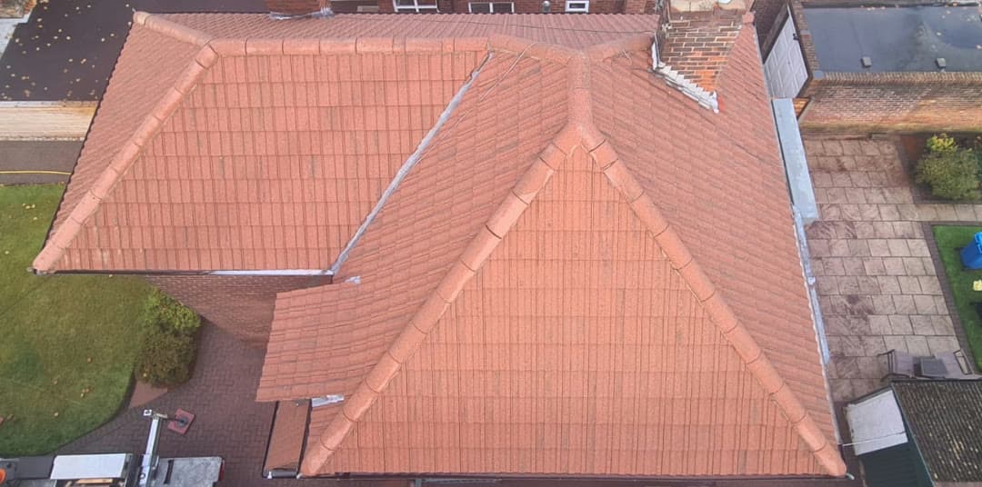 The same roof after a Blue Shield clean, the tiles back to bright terracotta